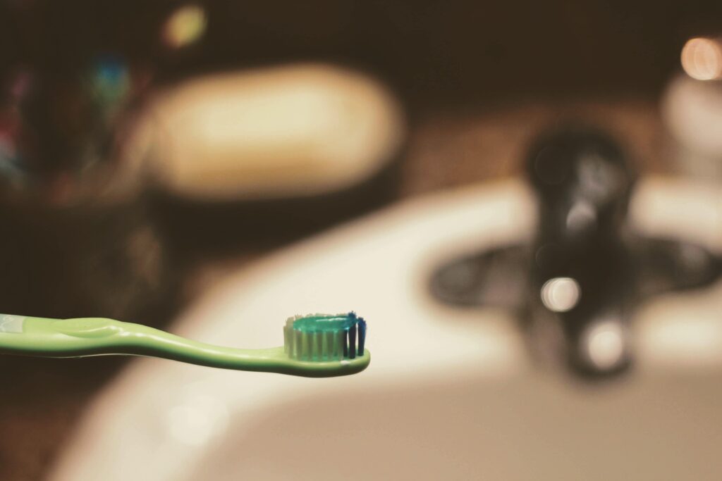 green toothbrush with a toothpaste